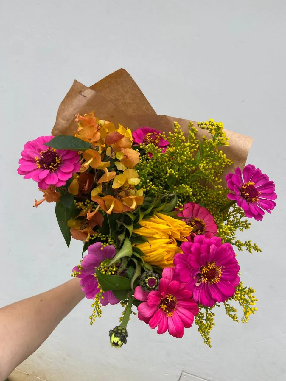 Bright pink and yellow zinnias with a sunflower